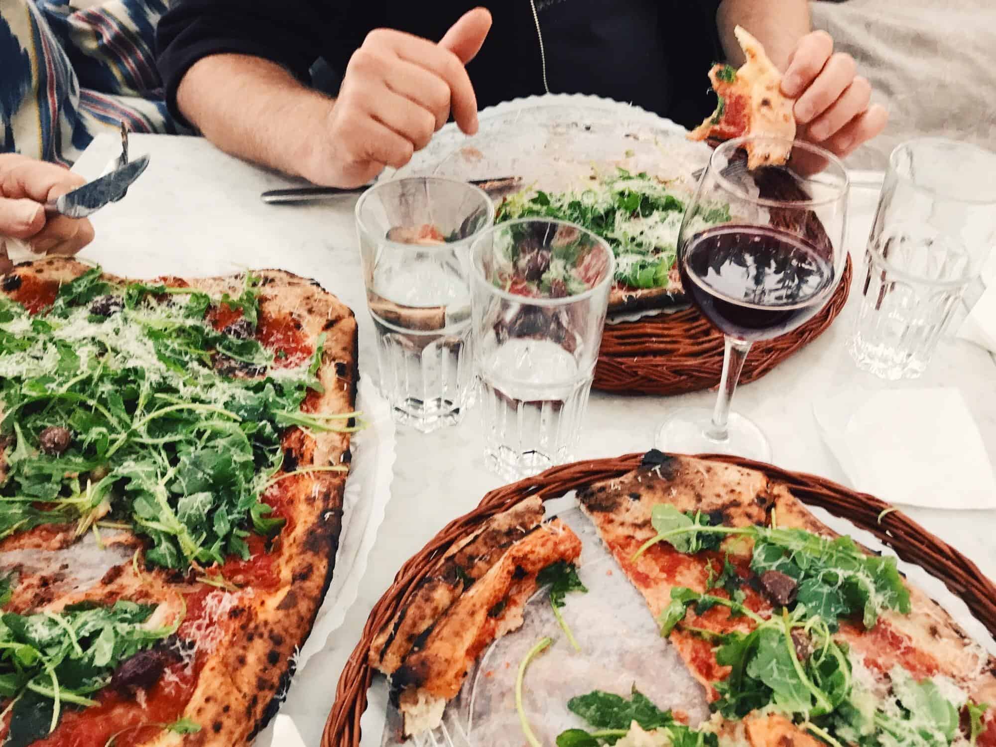 Pizza, salad, wine, dining experience.