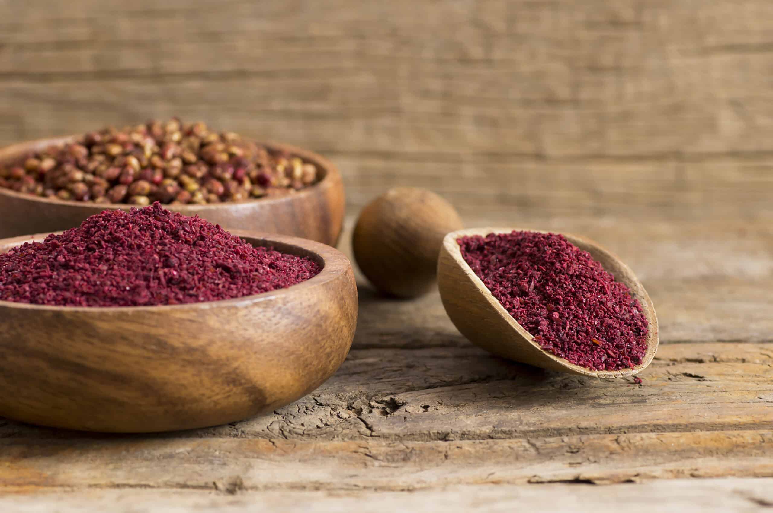 Wooden bowls with red spices and seeds