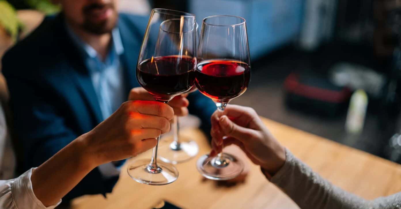 Cheers with red wine glasses